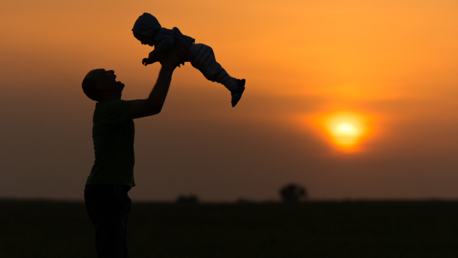 happy-dad-throws-baby-sunset